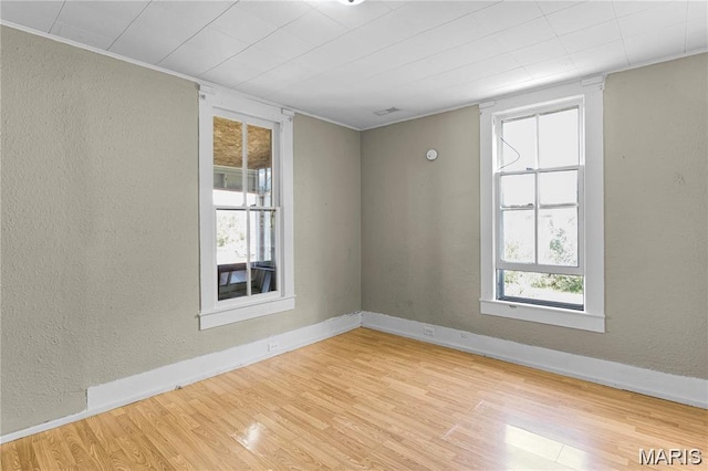 503 Newberry St, Fredericktown, MO 63645 - empty room with wood finished floors, a textured wall, and baseboards