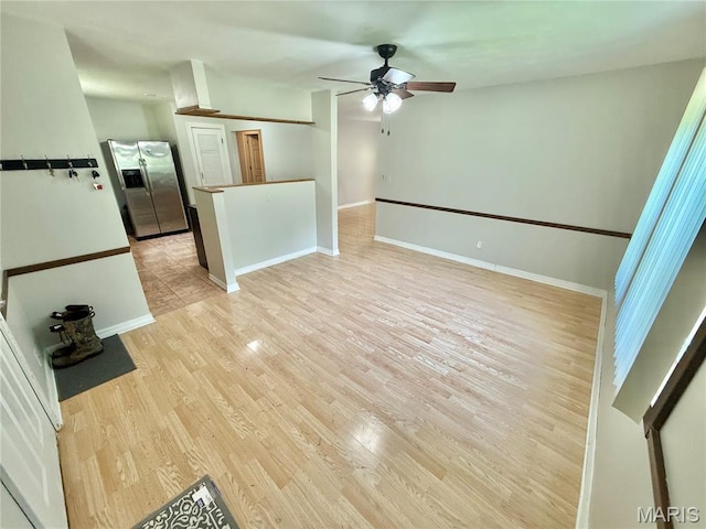 720 S Main St, Arcadia, MO 63621 - unfurnished living room with a ceiling fan, light wood finished floors, and baseboards