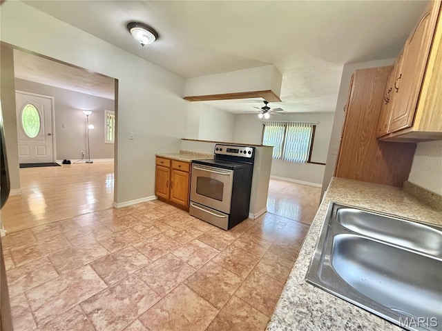 720 S Main St, Arcadia, MO 63621 - kitchen with stainless steel range with electric stovetop, light countertops, and ceiling fan
