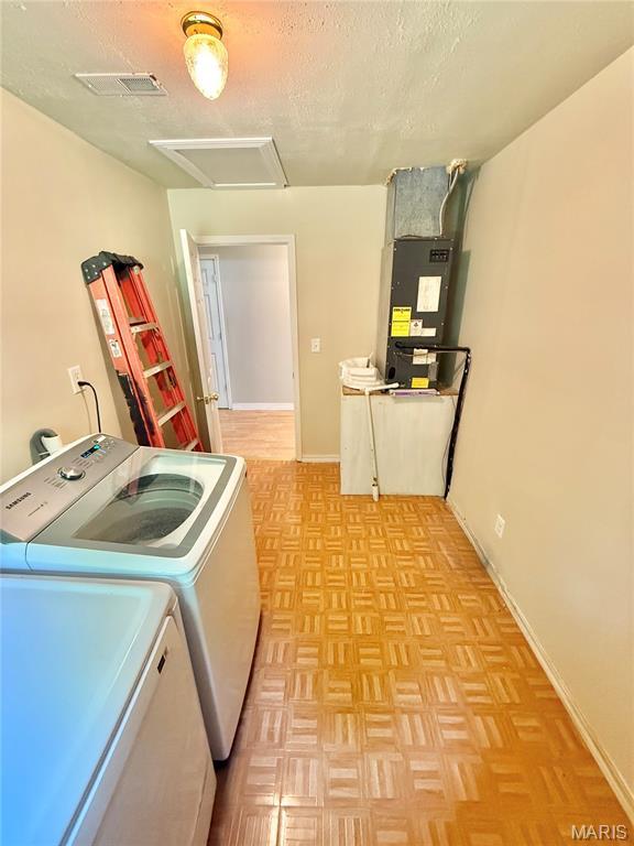 720 S Main St, Arcadia, MO 63621 - laundry room with washing machine and clothes dryer, a textured ceiling, attic access, heating unit, and baseboards