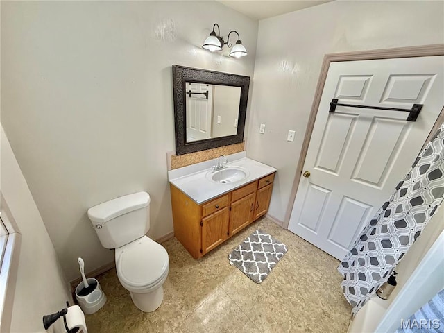 720 S Main St, Arcadia, MO 63621 - bathroom featuring vanity, toilet, and baseboards