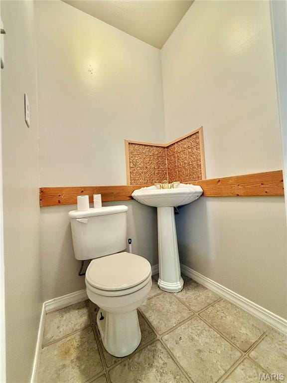 720 S Main St, Arcadia, MO 63621 - half bath featuring toilet, baseboards, and tile patterned flooring