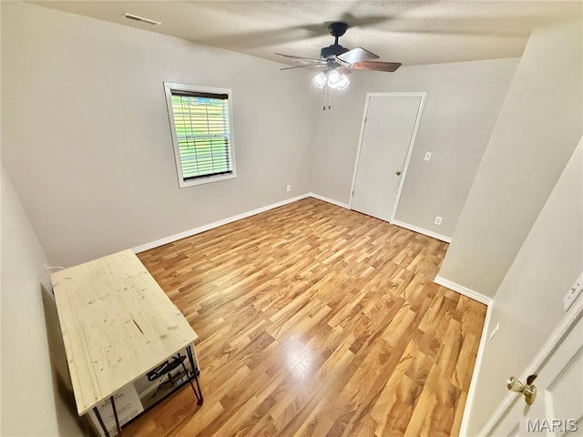 720 S Main St, Arcadia, MO 63621 - spare room with light wood-type flooring, a ceiling fan, and baseboards