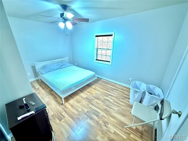 720 S Main St, Arcadia, MO 63621 - bedroom featuring wood finished floors, baseboards, and a ceiling fan