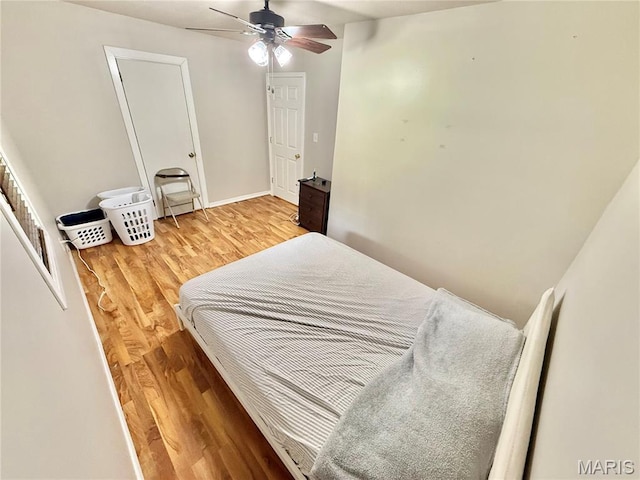720 S Main St, Arcadia, MO 63621 - bedroom with wood finished floors, baseboards, and a ceiling fan