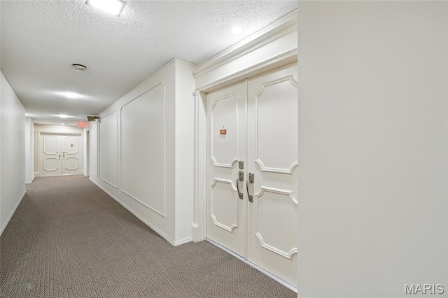 564 Sarah Ln Unit 103, Creve Coeur, MO 63141 - hall with a textured ceiling, carpet floors, and baseboards