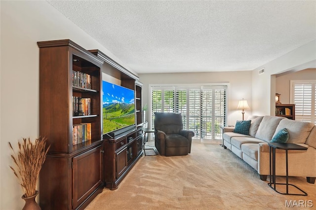 564 Sarah Ln Unit 103, Creve Coeur, MO 63141 - living area with light colored carpet and a textured ceiling