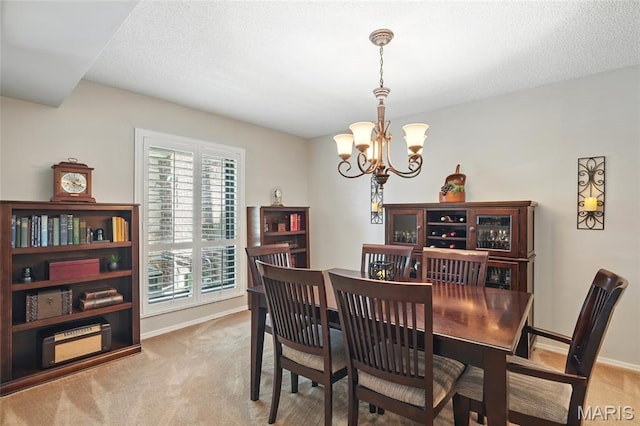 564 Sarah Ln Unit 103, Creve Coeur, MO 63141 - dining room featuring a chandelier, carpet flooring, baseboards, and a textured ceiling