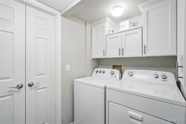 564 Sarah Ln Unit 103, Creve Coeur, MO 63141 - laundry area featuring washing machine and clothes dryer and cabinet space