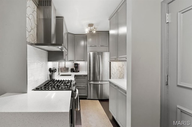 4466 W Pine Blvd Unit 6A, Saint Louis, MO 63108 - kitchen with stainless steel appliances, wall chimney range hood, gray cabinetry, tasteful backsplash, and light stone counters