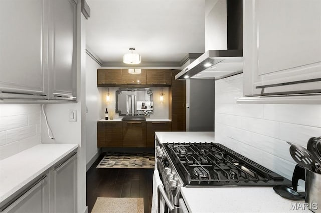 4466 W Pine Blvd Unit 6A, Saint Louis, MO 63108 - kitchen with wall chimney range hood, stainless steel range with gas cooktop, backsplash, and light countertops