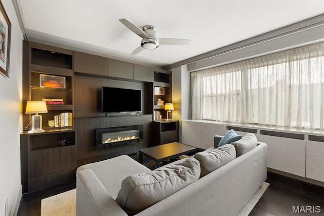 4466 W Pine Blvd Unit 6A, Saint Louis, MO 63108 - living area featuring a ceiling fan, a glass covered fireplace, wood finished floors, and built in features