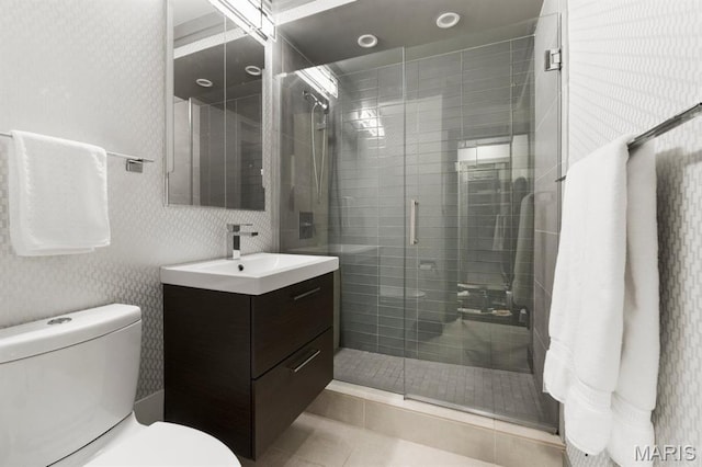 4466 W Pine Blvd Unit 6A, Saint Louis, MO 63108 - bathroom featuring vanity, toilet, a shower stall, and tile patterned floors