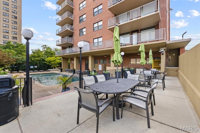 4466 W Pine Blvd Unit 6A, Saint Louis, MO 63108 - view of patio / terrace with a community pool, cooling unit, and outdoor dining area