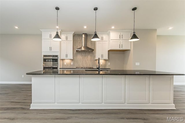8923 Gateway Hts Unit 94-805, Richmond Heights, MO 63144 - kitchen featuring wall chimney exhaust hood, appliances with stainless steel finishes, white cabinetry, baseboards, and recessed lighting