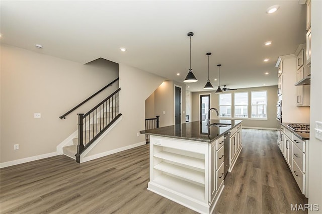 8923 Gateway Hts Unit 94-805, Richmond Heights, MO 63144 - kitchen featuring open shelves, a center island with sink, a sink, dark wood-style flooring, and recessed lighting