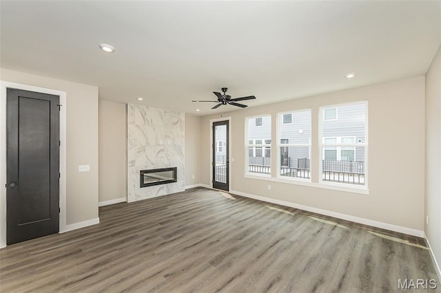 8923 Gateway Hts Unit 94-805, Richmond Heights, MO 63144 - unfurnished living room with baseboards, recessed lighting, wood finished floors, a ceiling fan, and a premium fireplace