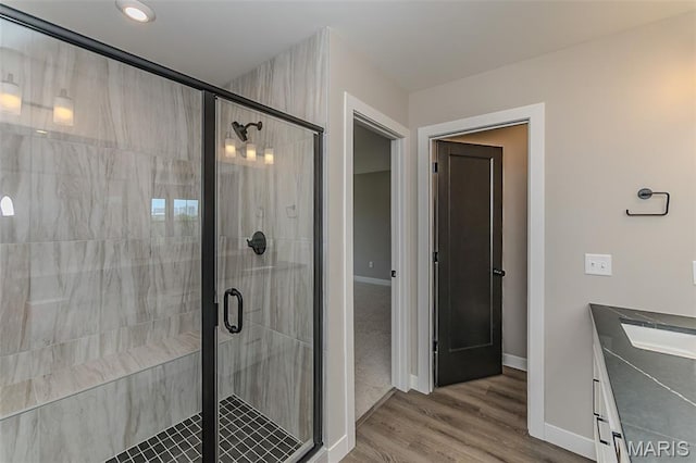 8923 Gateway Hts Unit 94-805, Richmond Heights, MO 63144 - full bath with vanity, a stall shower, baseboards, and wood finished floors