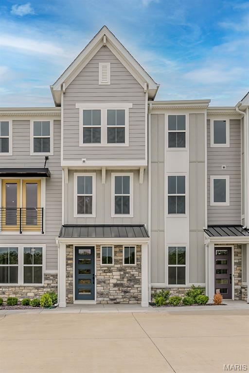 8923 Gateway Hts Unit 94-805, Richmond Heights, MO 63144 - view of front facade with a standing seam roof and stone siding
