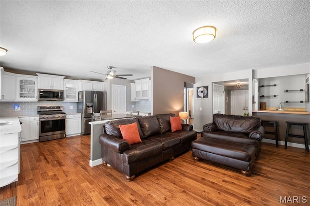 116 Lea Meadows Dr, Ballwin, MO 63011 - living room with a textured ceiling, ceiling fan, and wood finished floors