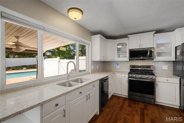 116 Lea Meadows Dr, Ballwin, MO 63011 - kitchen with stainless steel appliances, a sink, white cabinets, glass insert cabinets, and decorative backsplash