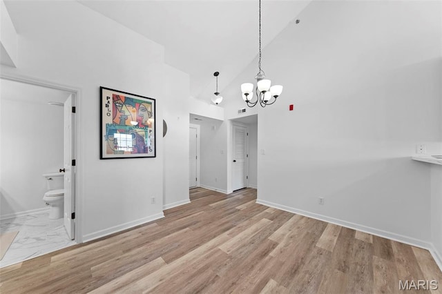 9740 Bexley Station Dr Unit 7J, Concord Township, MO 63123 - unfurnished dining area featuring a chandelier, high vaulted ceiling, baseboards, and wood finished floors