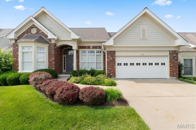 15921 Picardy Crest Ct, Chesterfield, MO 63017 - view of front of property with brick siding, driveway, a front yard, an attached garage, and a shingled roof