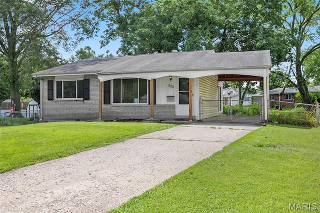 220 Versailles Dr, Florissant, MO 63031 - view of front facade featuring concrete driveway, a gate, brick siding, roof with shingles, and a carport