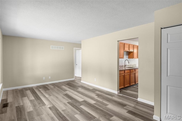 220 Versailles Dr, Florissant, MO 63031 - empty room with wood finished floors and a textured ceiling