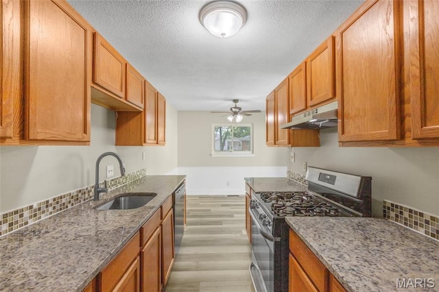 220 Versailles Dr, Florissant, MO 63031 - kitchen with stainless steel appliances, under cabinet range hood, light wood-style floors, ceiling fan, and light stone counters