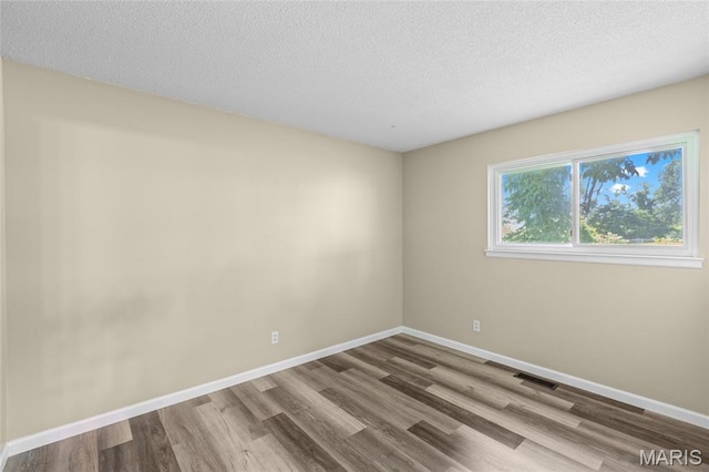220 Versailles Dr, Florissant, MO 63031 - unfurnished room with wood finished floors and a textured ceiling