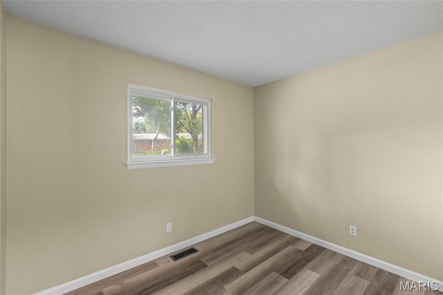 220 Versailles Dr, Florissant, MO 63031 - empty room with wood finished floors and baseboards