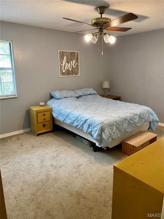 702 E Silver, Naylor, MO 63953 - carpeted bedroom with baseboards, a textured ceiling, and ceiling fan
