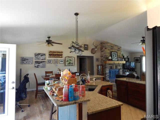6230 Cuivre Ford Rd, Troy, MO 63379 - kitchen featuring ceiling fan, lofted ceiling, a sink, open floor plan, and a stone fireplace