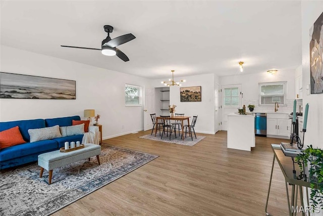 216 Clearpoint Ln, Saint Louis, MO 63123 - living area with a chandelier, plenty of natural light, wood finished floors, and a ceiling fan