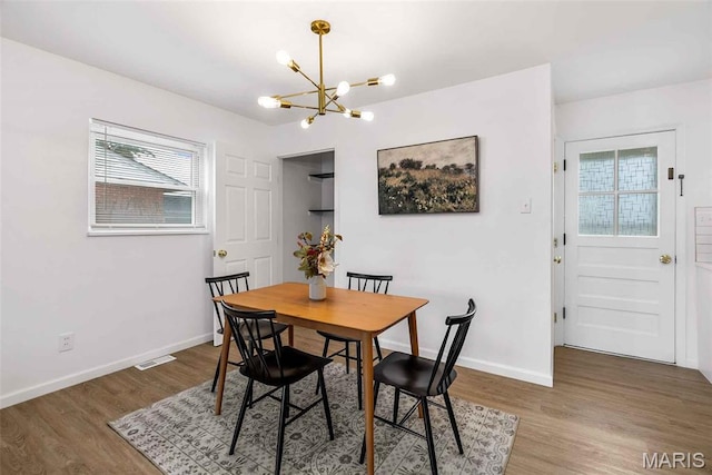 216 Clearpoint Ln, Saint Louis, MO 63123 - dining area featuring a chandelier, plenty of natural light, and wood finished floors