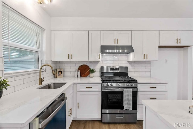 216 Clearpoint Ln, Saint Louis, MO 63123 - kitchen with under cabinet range hood, stainless steel appliances, a sink, white cabinetry, and light stone counters