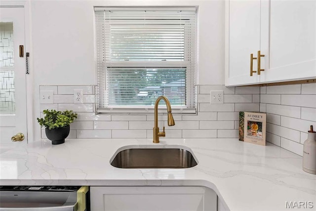 216 Clearpoint Ln, Saint Louis, MO 63123 - kitchen with a sink, dishwasher, white cabinets, and decorative backsplash