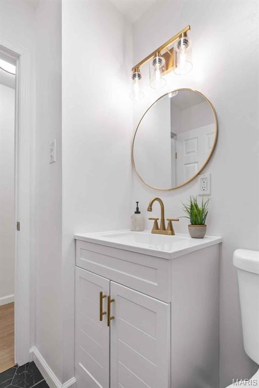216 Clearpoint Ln, Saint Louis, MO 63123 - half bath featuring vanity, toilet, and baseboards