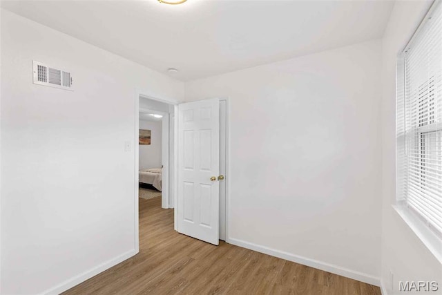 216 Clearpoint Ln, Saint Louis, MO 63123 - spare room with baseboards and light wood-style flooring