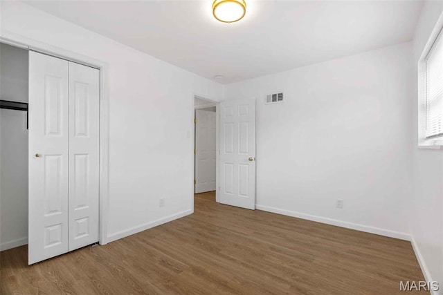 216 Clearpoint Ln, Saint Louis, MO 63123 - unfurnished bedroom featuring wood finished floors, baseboards, and a closet