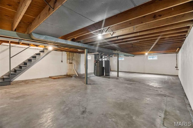 216 Clearpoint Ln, Saint Louis, MO 63123 - basement featuring stairs, gas water heater, and heating unit