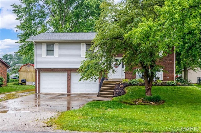 1170 Bond St, Carlyle, IL 62231 - view of front of house featuring brick siding, driveway, a garage, and a front yard