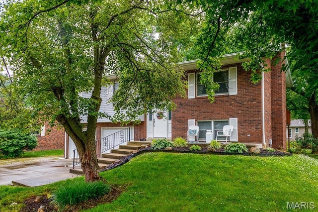 1170 Bond St, Carlyle, IL 62231 - bi-level home with brick siding, a front yard, and driveway