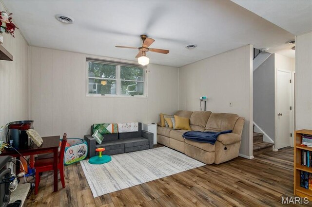 1170 Bond St, Carlyle, IL 62231 - living room with wood finished floors, a ceiling fan, and stairs