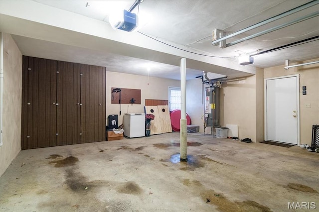 1170 Bond St, Carlyle, IL 62231 - garage featuring water heater, a garage door opener, and refrigerator