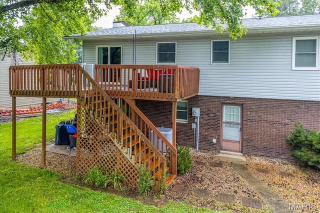 1170 Bond St, Carlyle, IL 62231 - rear view of house with brick siding, a deck, a chimney, and a lawn
