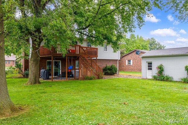 1170 Bond St, Carlyle, IL 62231 - back of property with a wooden deck, stairway, a lawn, and brick siding