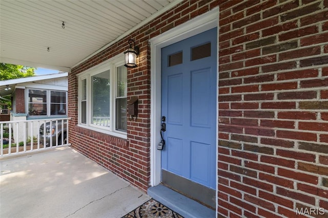 8217 Buchanan Ave, Saint Louis, MO 63114 - entrance to property featuring covered porch and brick siding