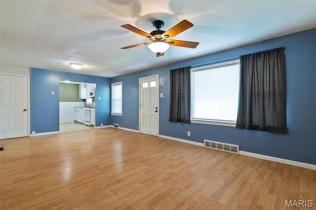 8217 Buchanan Ave, Saint Louis, MO 63114 - unfurnished living room with wood finished floors and a ceiling fan